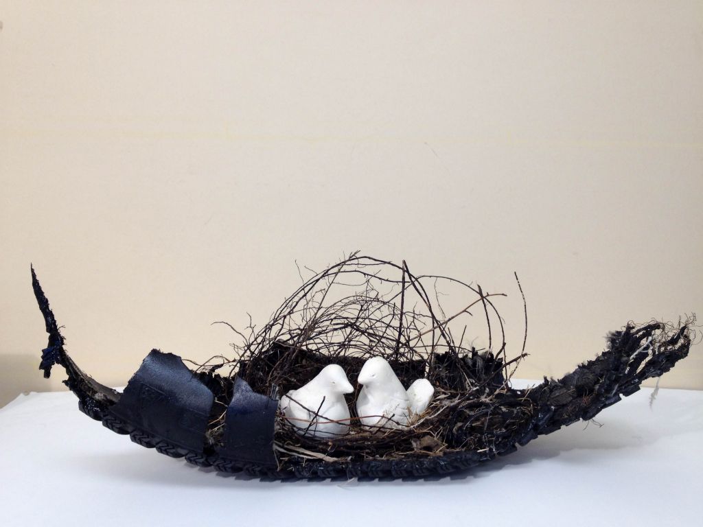 Dove Song, mixed media, tire piece, sticks, string, hair, feathers, clay, 7"H x 20"W x 7"D